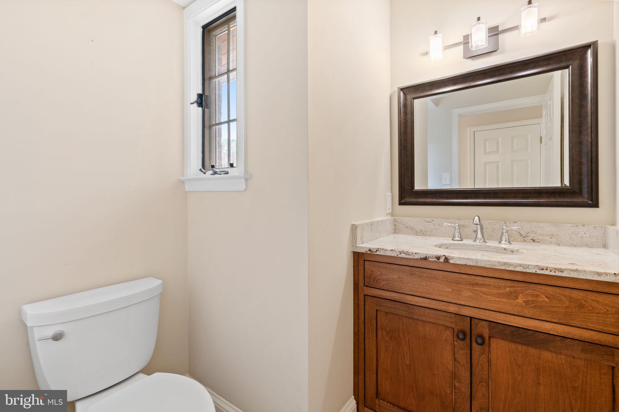 115 Roumfort Road, Unit 26 Philadelphia, PA 19119 - Photo 5 of 33 a bathroom with a toilet sink and mirror
