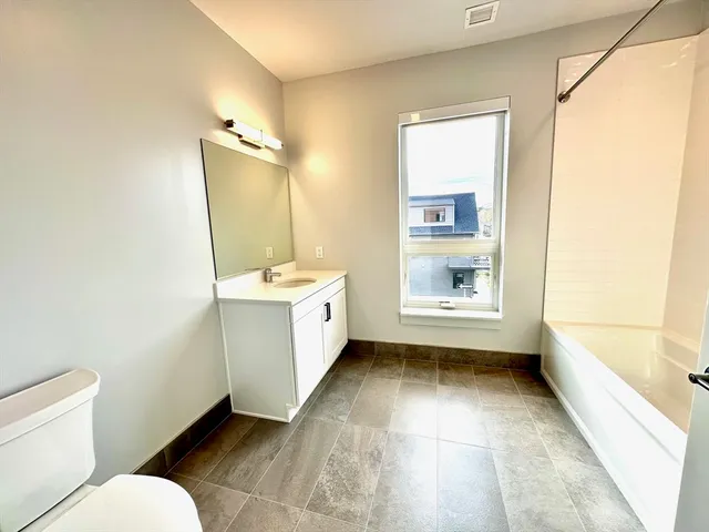 a bathroom with a sink a toilet and tub