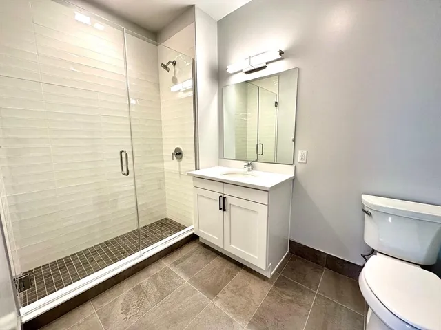 a bathroom with a toilet sink and shower