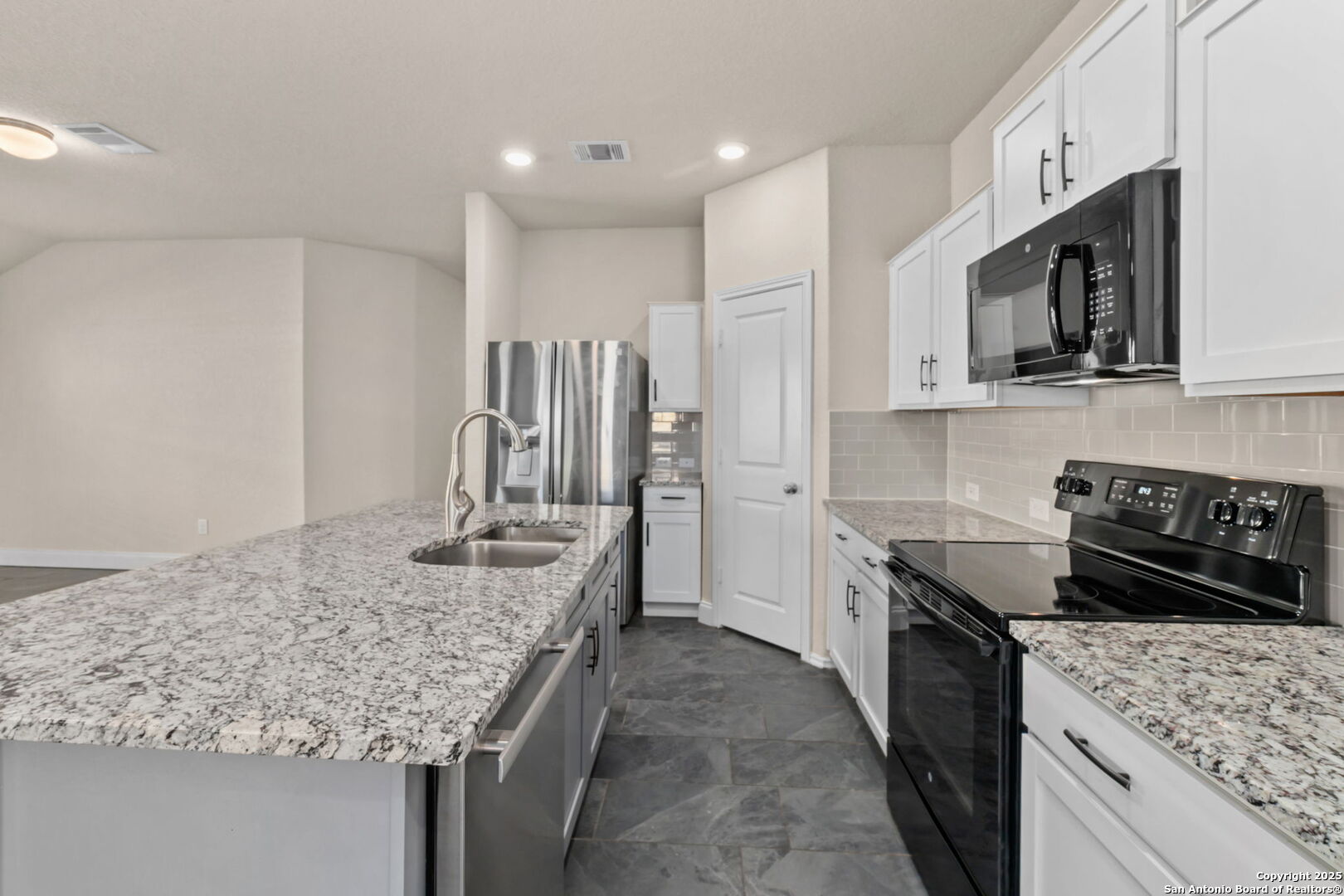 10306 Midsummer Meadow Converse, TX 78109 - Photo 13 of 20 a kitchen with stainless steel appliances granite countertop a sink stove and refrigerator
