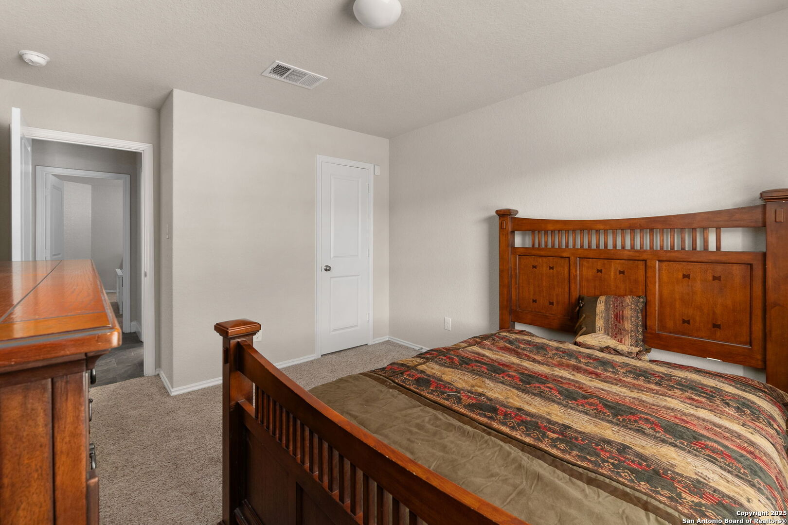 10306 Midsummer Meadow Converse, TX 78109 - Photo 5 of 20 a bedroom with a bed and a mirror