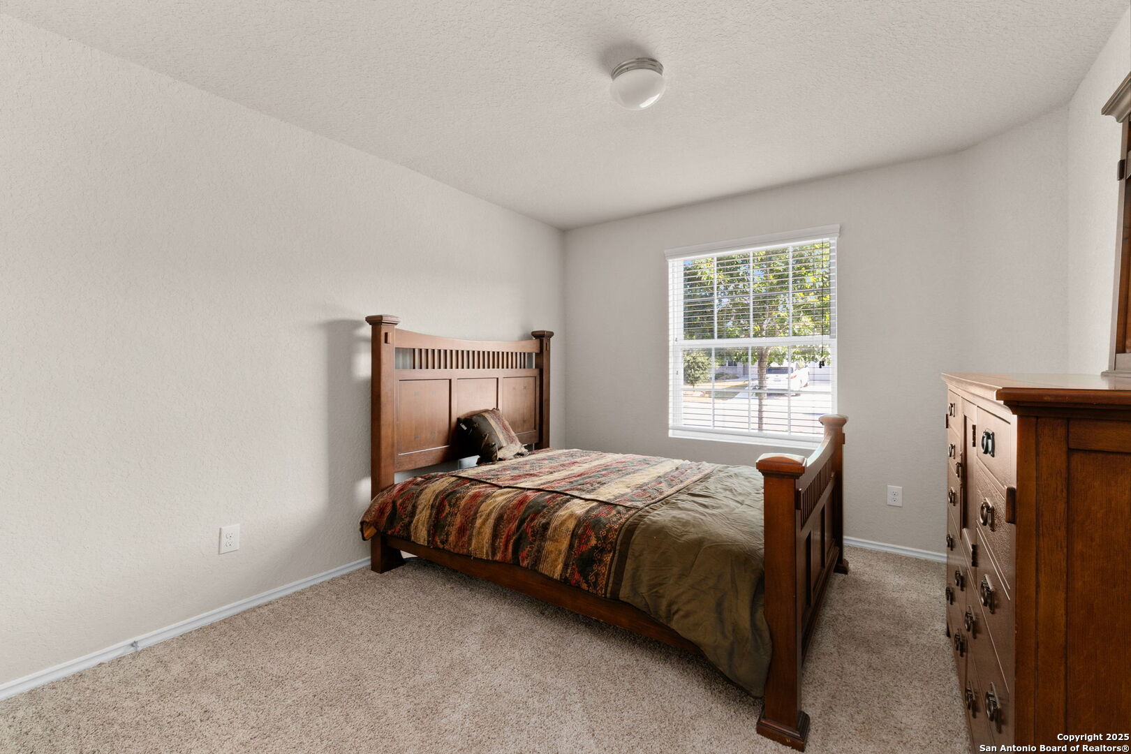 10306 Midsummer Meadow Converse, TX 78109 - Photo 6 of 20 a bedroom with a bed and a window
