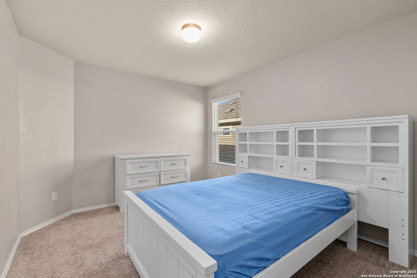 10306 Midsummer Meadow Converse, TX 78109 - Photo 8 of 20 a bedroom with a bed and a window