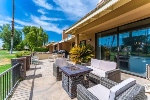 a building outdoor space with patio furniture and garden