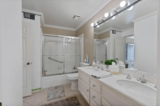a bathroom with a double vanity sink mirror double and shower