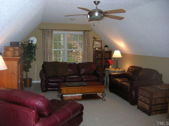 640 Lanes Mill Road Bennett, NC 27208 - Photo 5 of 12 a living room with furniture a ceiling fan and a window