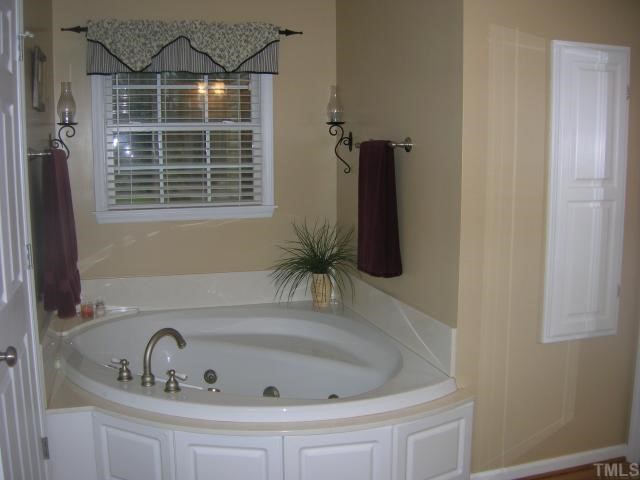 640 Lanes Mill Road Bennett, NC 27208 - Photo 7 of 12 a bathroom with a tub and a sink