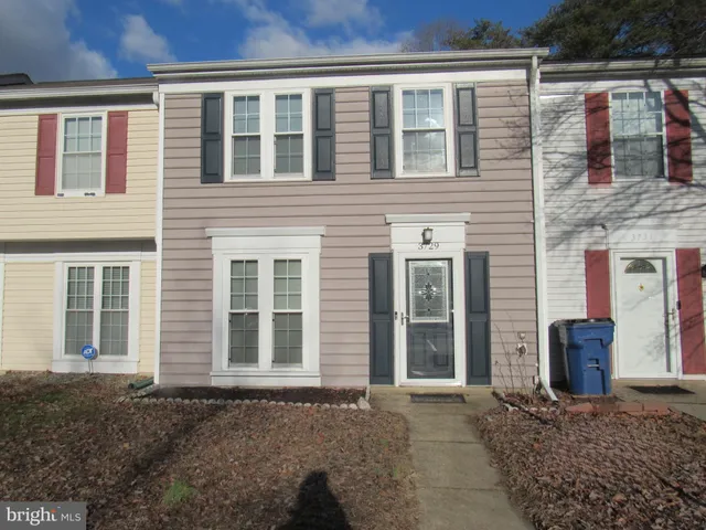 front view of a brick house with many windows