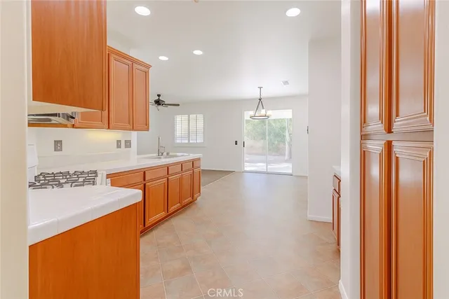 a view of a kitchen with a sink and chandelier