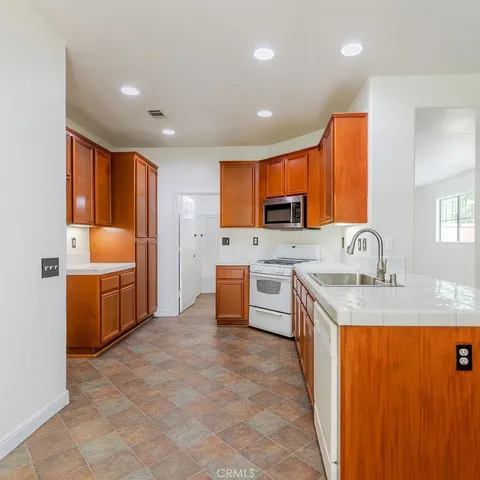 a view of a kitchen with a sink cabinets and wooden floor