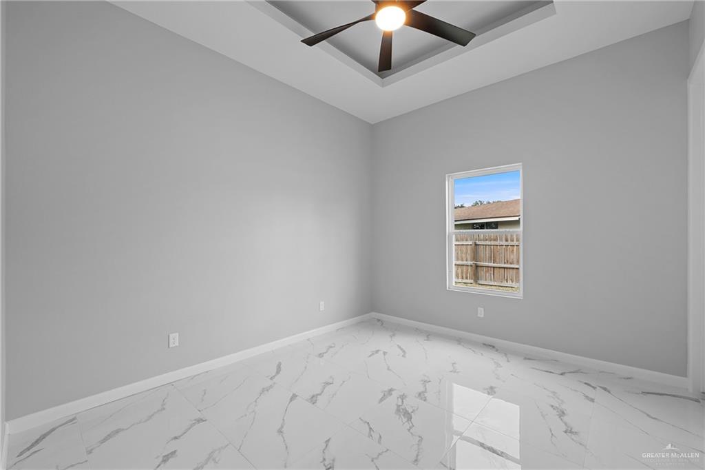5100 Duke Avenue McAllen, TX 78504 - Photo 13 of 24 an empty room with a ceiling fan and window