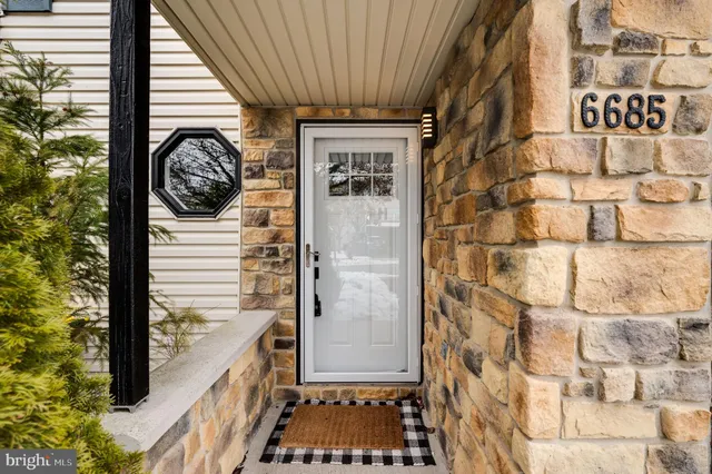 a view of a with white house with snow on the road