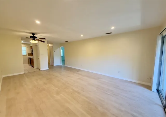 an empty room with wooden floor