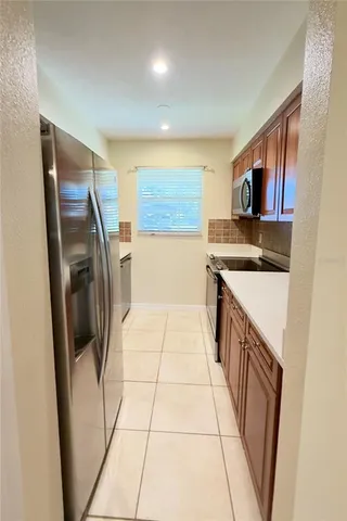 a kitchen with stainless steel appliances a refrigerator and a sink