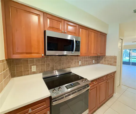 a kitchen with a sink and a stove top oven