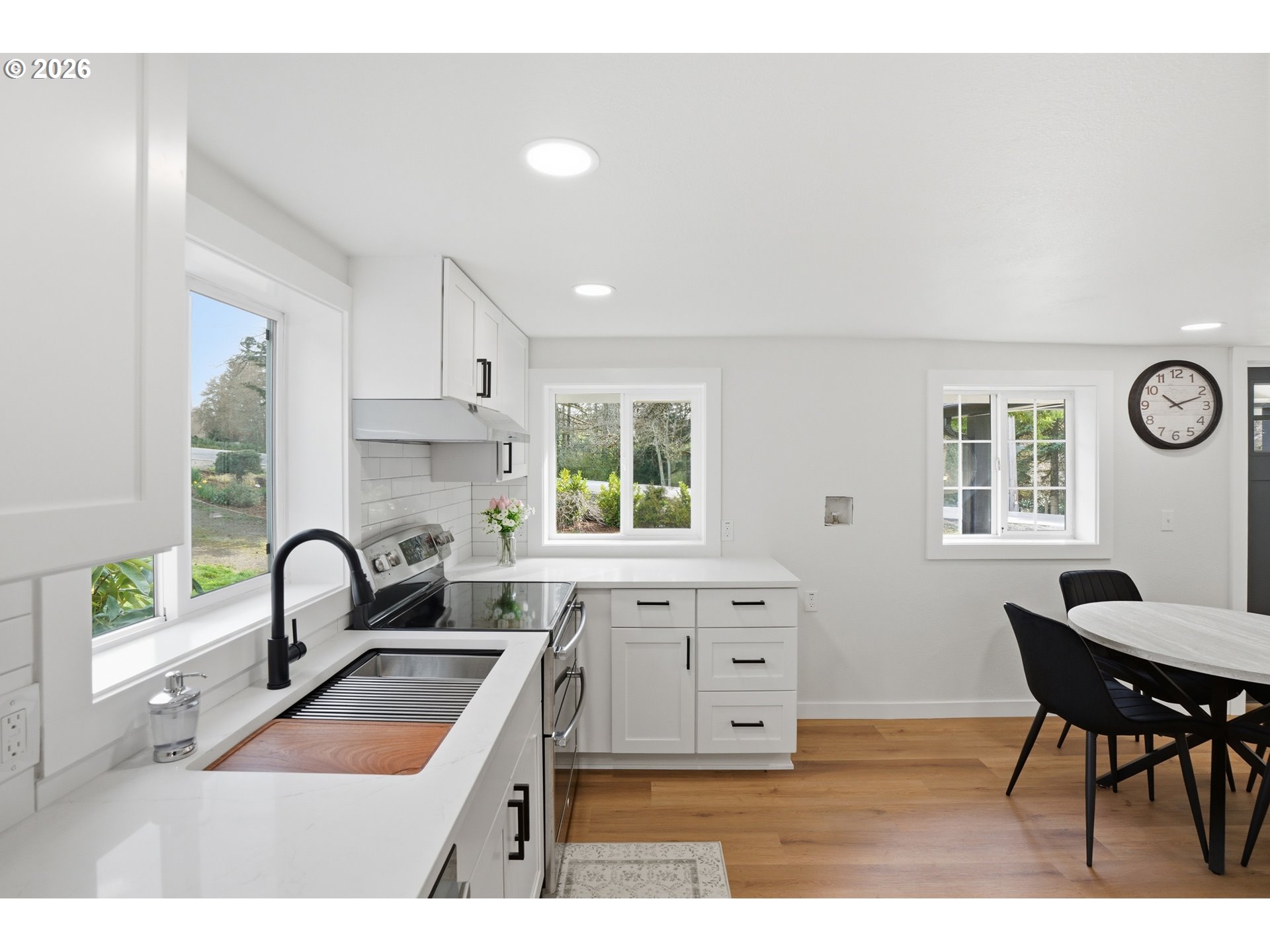 8207 Southeast Cottrell Road Gresham, OR 97080 - Photo 18 of 42 a kitchen with granite countertop a sink and a stove top oven