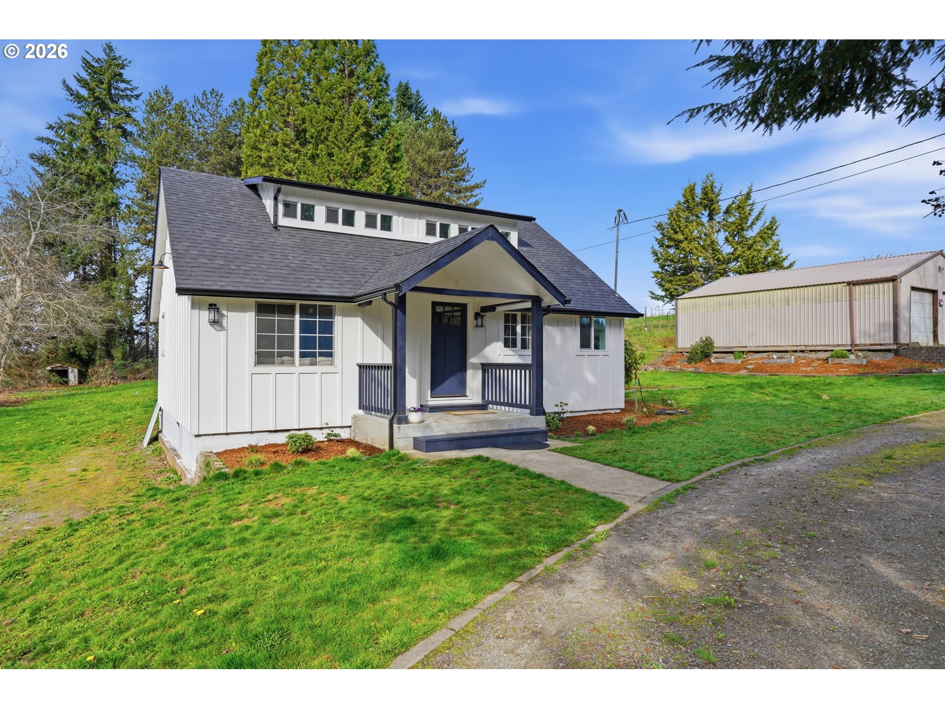 8207 Southeast Cottrell Road Gresham, OR 97080 - Photo 2 of 42 a front view of a house with a garden and yard