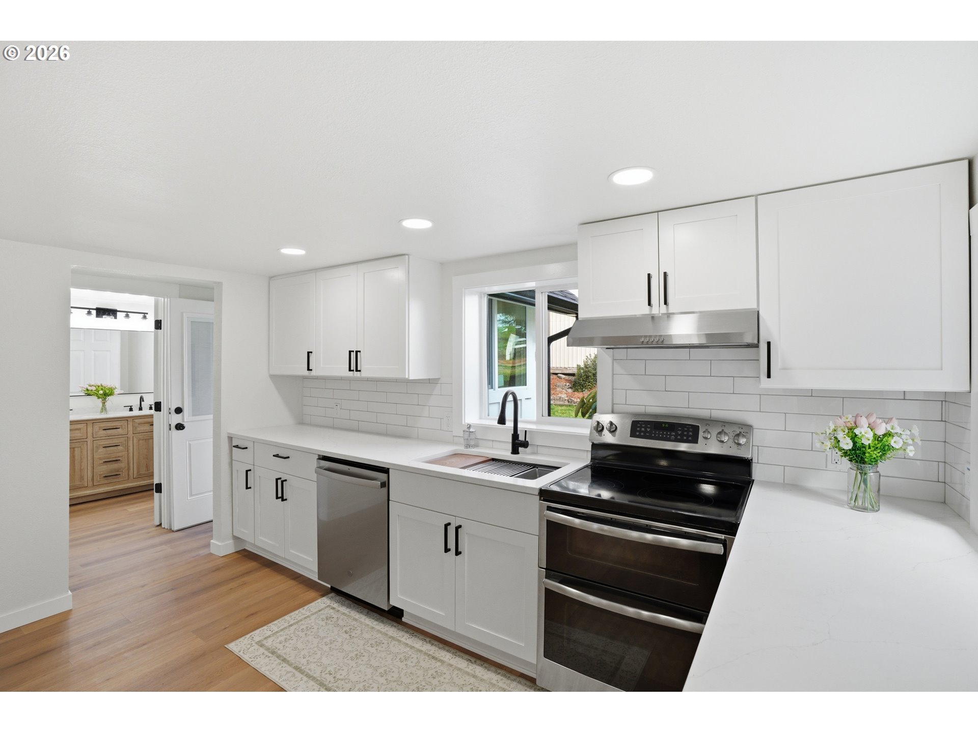 8207 Southeast Cottrell Road Gresham, OR 97080 - Photo 23 of 42 a kitchen with stainless steel appliances kitchen island granite countertop a stove a sink and a refrigerator