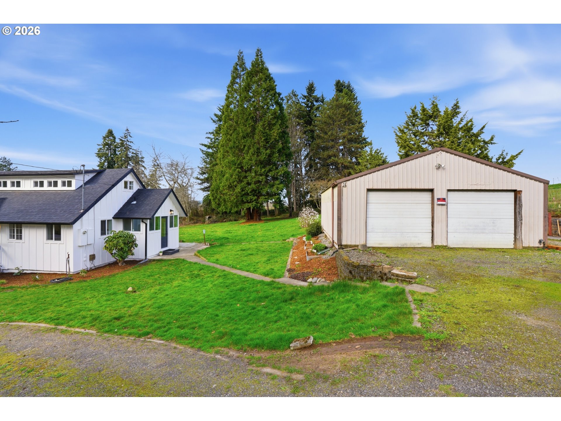 8207 Southeast Cottrell Road Gresham, OR 97080 - Photo 7 of 42 a front view of a house with a yard and garage