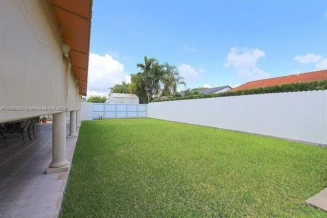 a view of yard with swimming pool and seating area