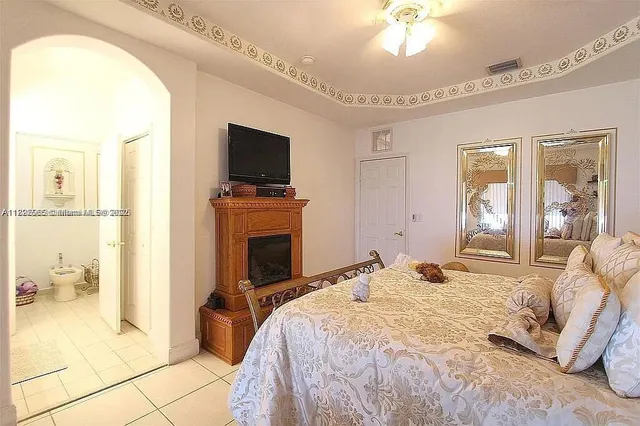 a bedroom with a bed and a television