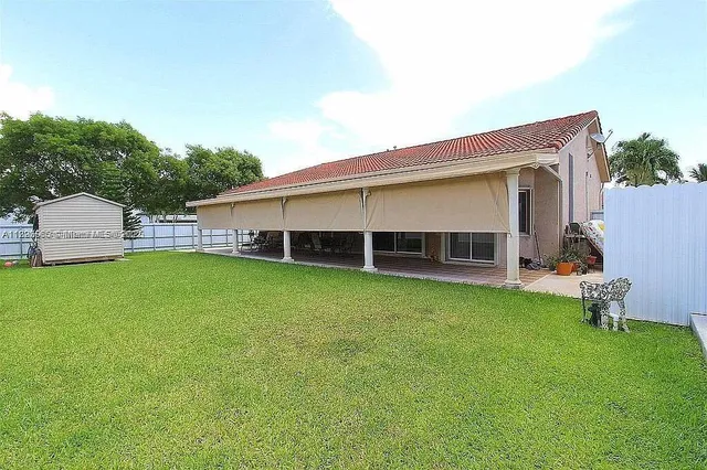 a view of a house with a backyard