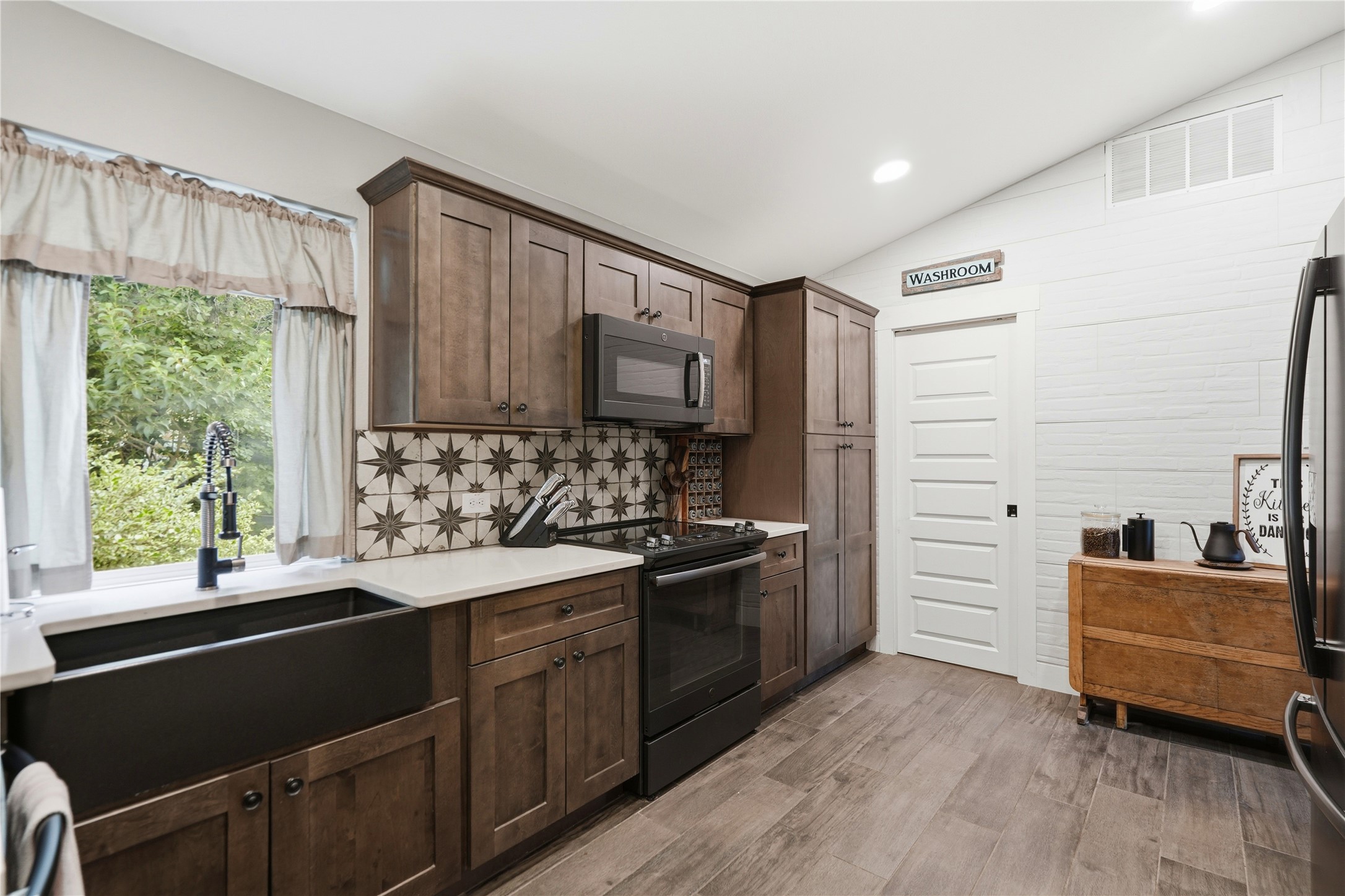 18406 Roundrock Road Jonestown, TX 78645 - Photo 24 of 33 a kitchen with a sink stove and refrigerator