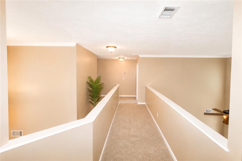 2078 Autumn Ridge Way Auburn, AL 36879 - Photo 13 of 24 Carpeted hallway with neutral wall tones and crown molding