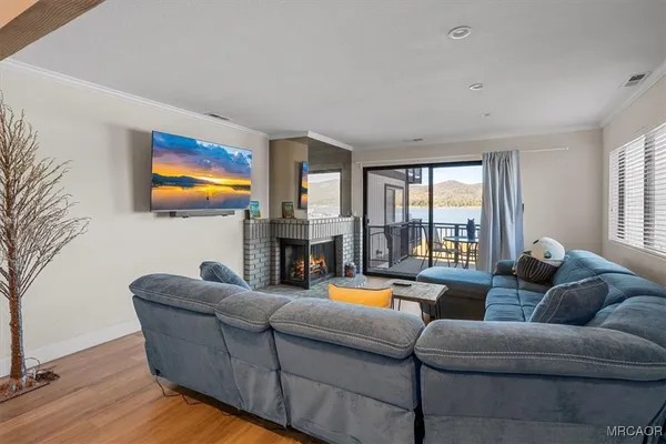 a living room with fireplace furniture and a flat screen tv