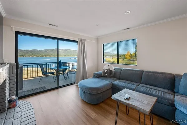 a living room with furniture and a floor to ceiling window