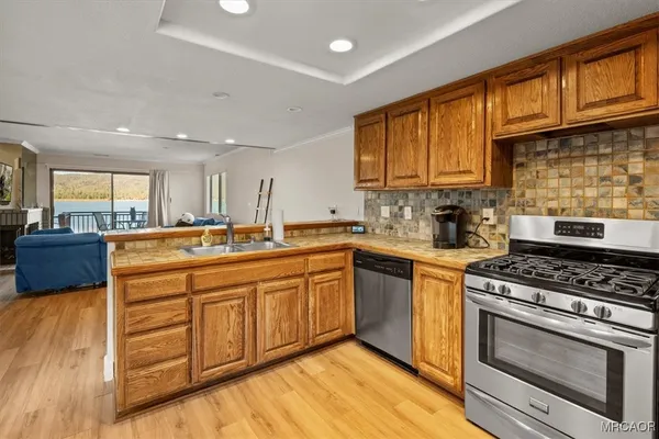 a kitchen with stainless steel appliances granite countertop a stove and a sink