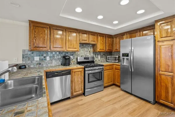 a kitchen with a refrigerator sink and stove