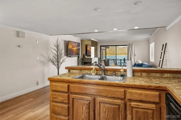 a kitchen with a sink and a wooden cabinets