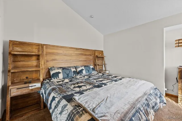 a bedroom with a bed and a fireplace