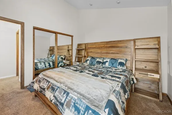 a bedroom with a bed and a large window