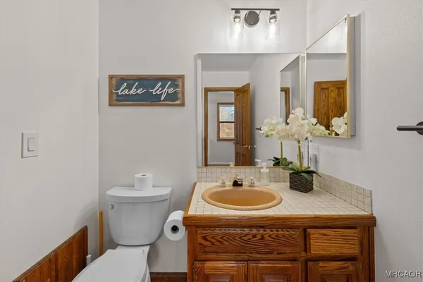 a bathroom with a sink a mirror and a toilet