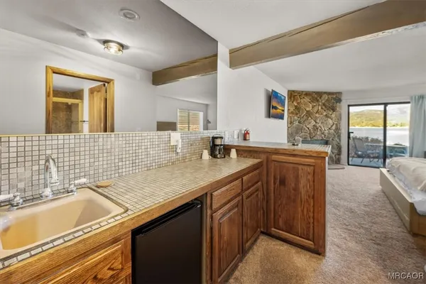 a bathroom with a granite countertop sink and a bathtub