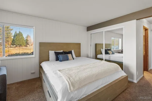 a bedroom with a large bed and a window