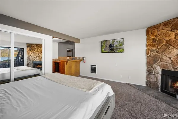 a bedroom with a bed and a fireplace