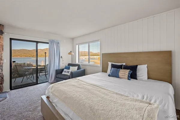 a bedroom with a large bed and a large window