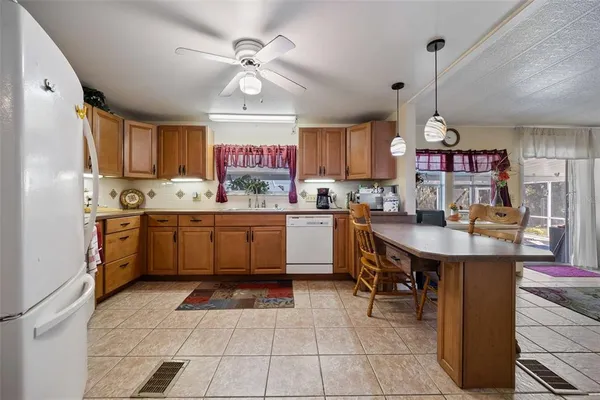 a kitchen with sink cabinets and refrigerator