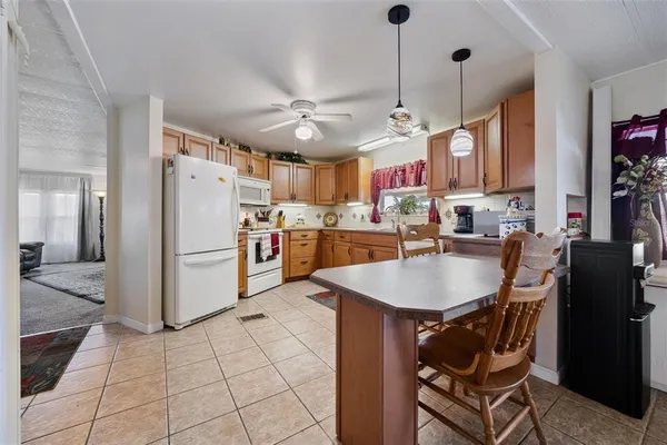 a kitchen with stainless steel appliances granite countertop a sink and a white cabinets