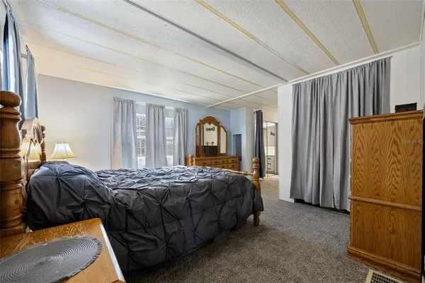 a bedroom with a bed and a lamp