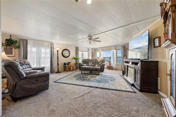 a living room with furniture and a clock