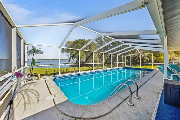 a swimming pool with outdoor seating