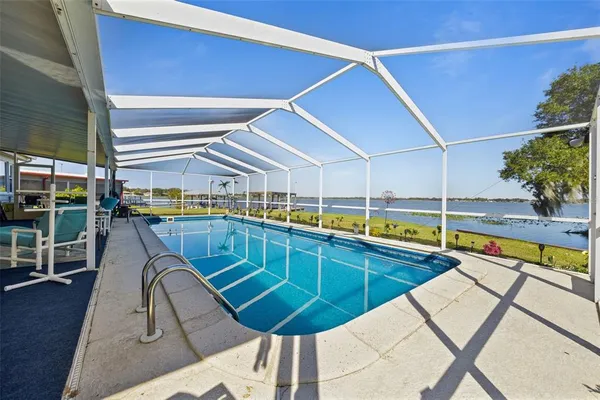 a view of a house with a swimming pool and a yard