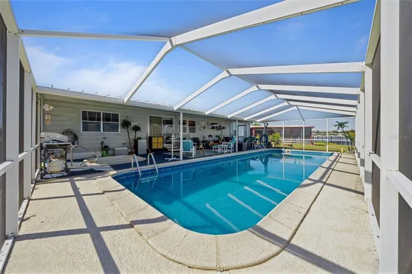 a view of a swimming pool with an outdoor space and seating area