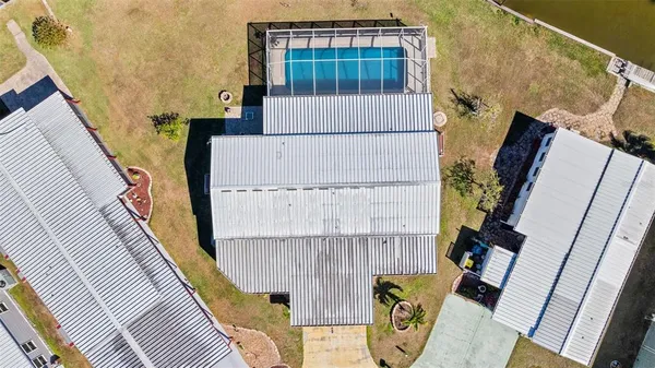 an aerial view of a house with a swimming pool