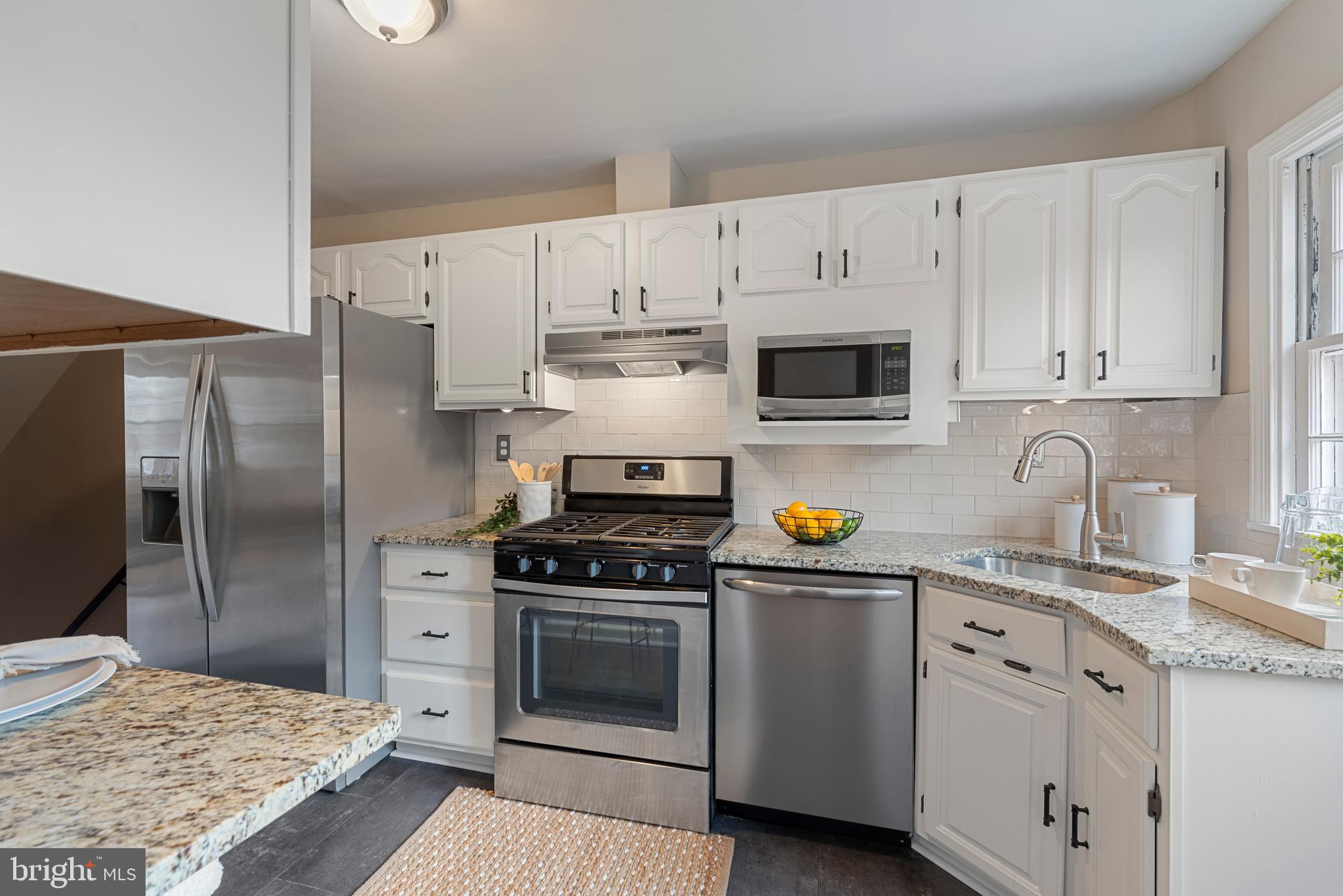 183 Stanmore Road Baltimore, MD 21212 - Photo 23 of 54 a kitchen with stainless steel appliances granite countertop a stove a sink dishwasher and a refrigerator