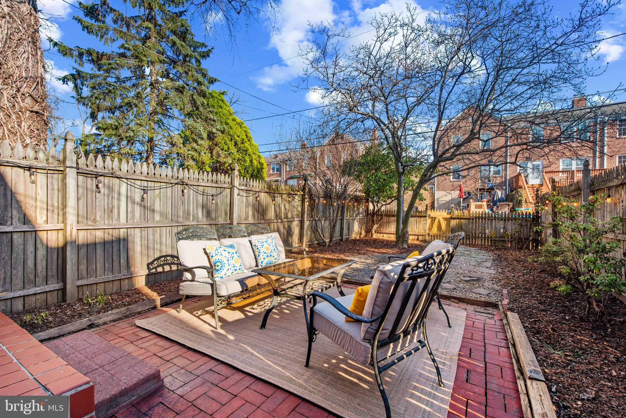183 Stanmore Road Baltimore, MD 21212 - Photo 46 of 54 a view of a patio with table and chairs and floor with wooden fence and plants